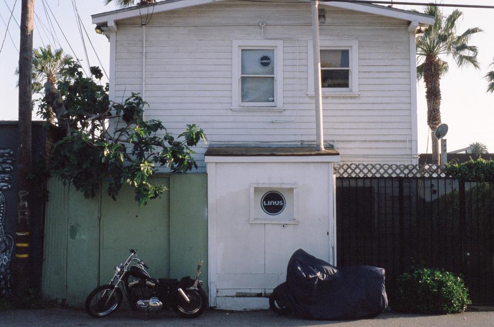 Free Image of Two Motorcycles Parked in Front of a House 