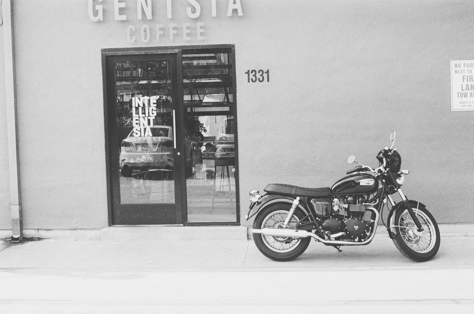 Free Image of Motorcycle Parked in Front of Coffee Shop 