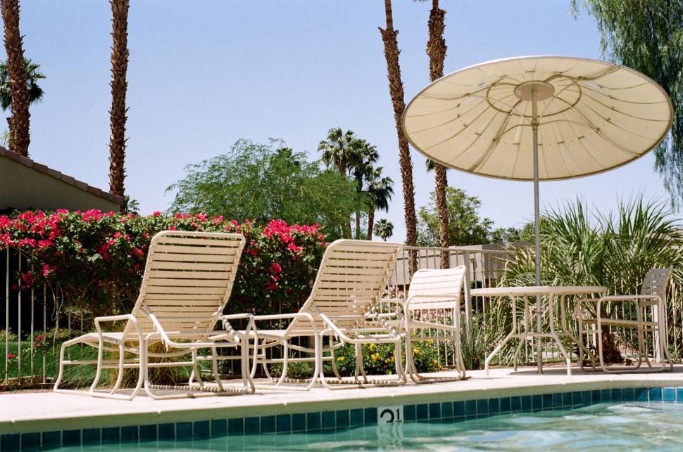 Free Image of Pool With Chairs and Umbrella 