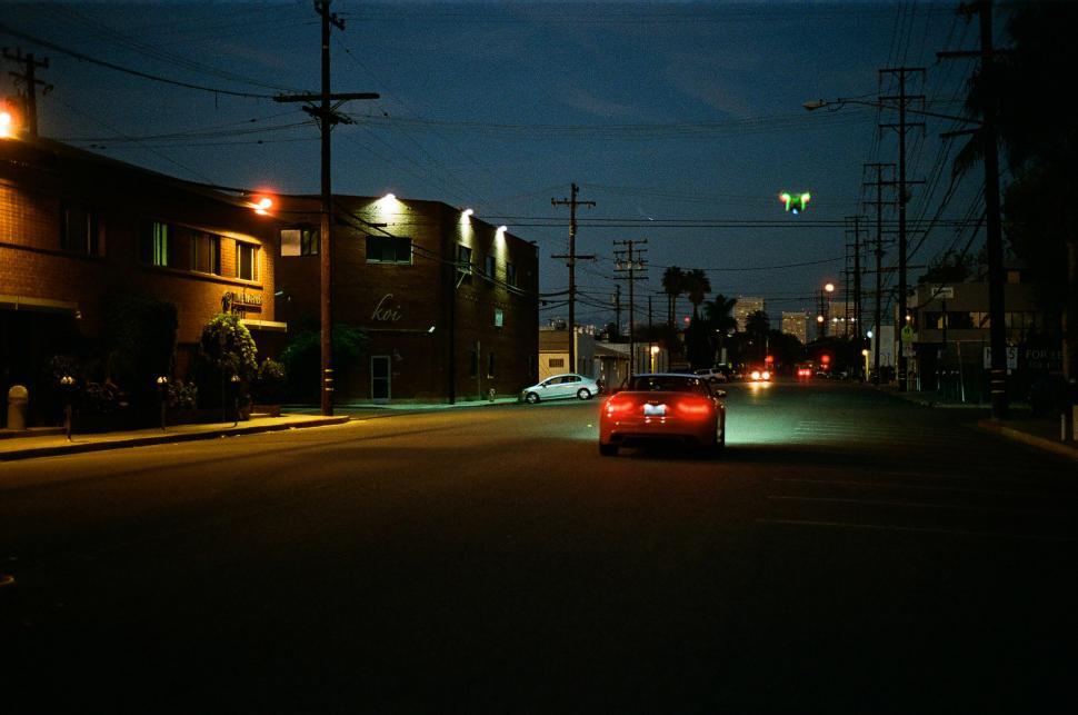 Free Image of Car Driving Down Night Street 