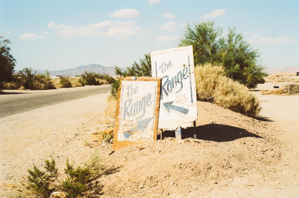 Free Image of Sign Standing in Middle of Dirt Road 