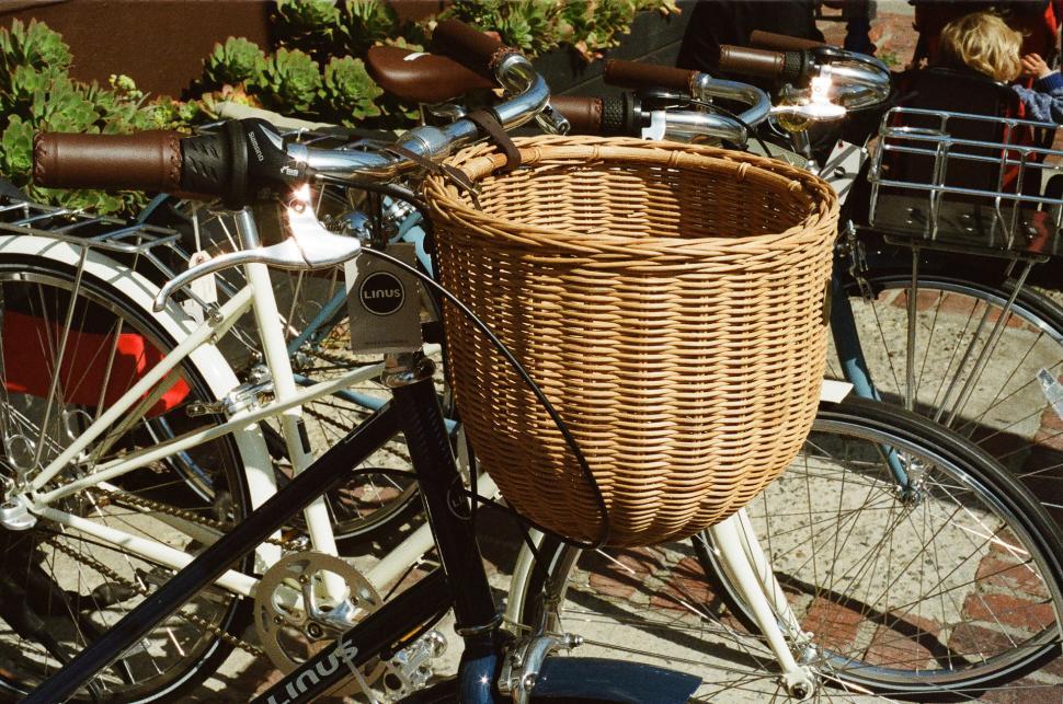 Free Image of Bicycle With Wicker Basket Among Other Parked Bicycles 