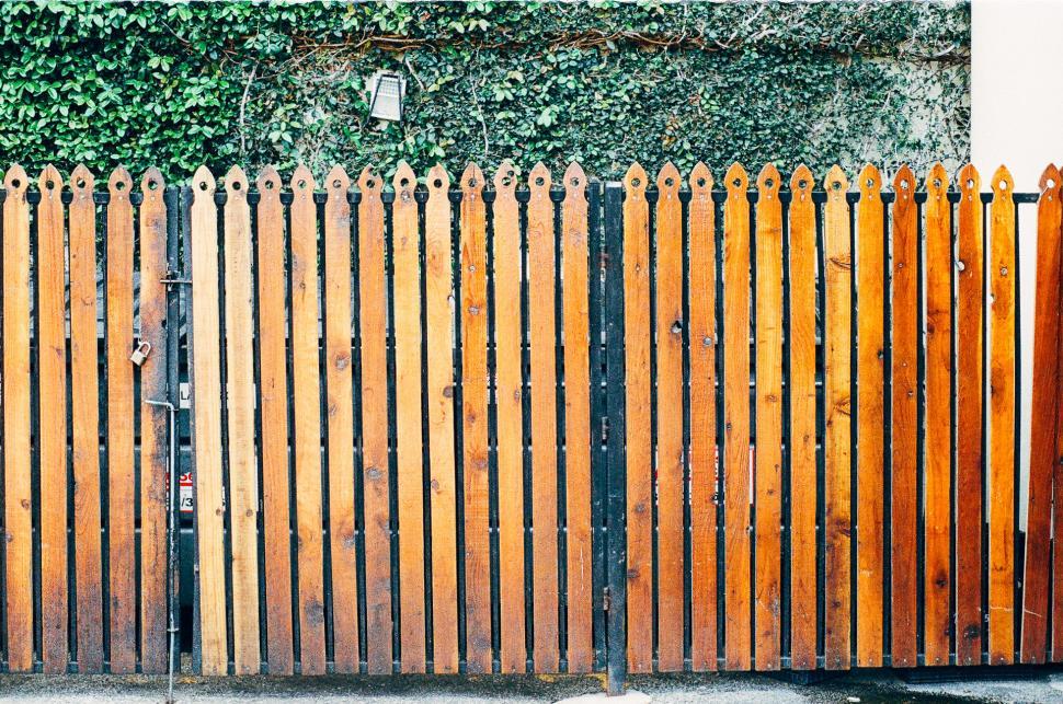 Free Image of Tall Wooden Fence Next to a Building 