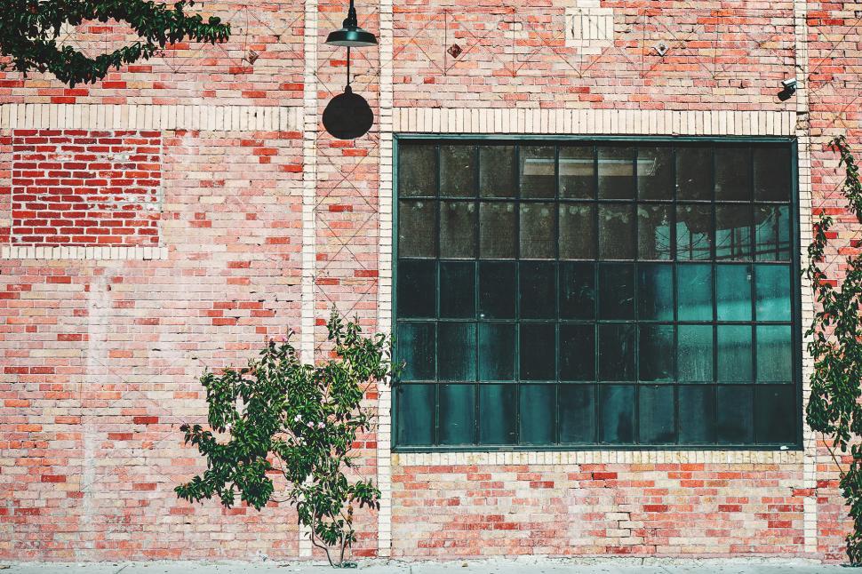 Free Image of Red Brick Building With Green Window 