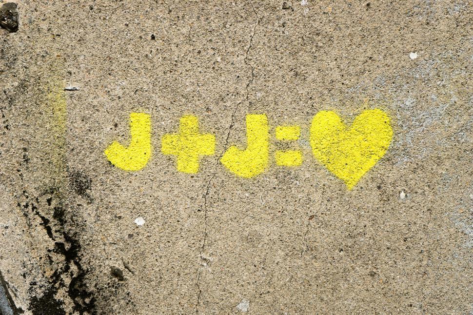 Free Image of Yellow Painted Word on Sidewalk 