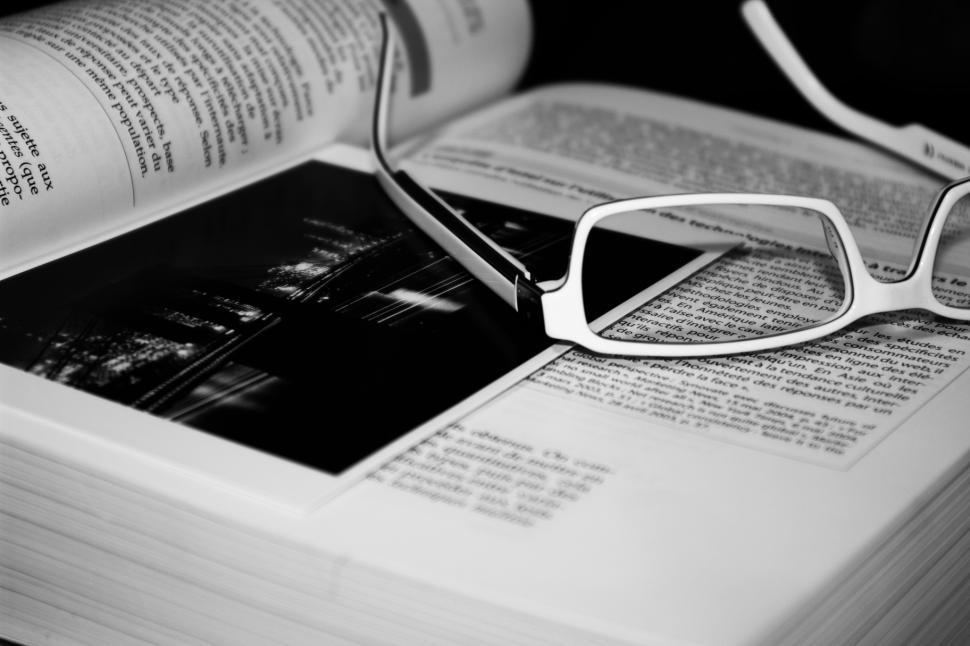 Free Image of Glasses on Open Book 