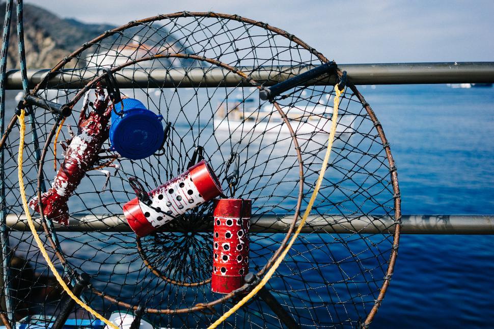 Free Image of Fishing Net Close Up With Boat in Background 