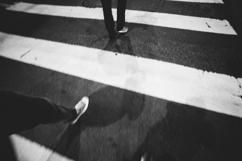 Free Image of Person Walking Across Crosswalk in the Dark 