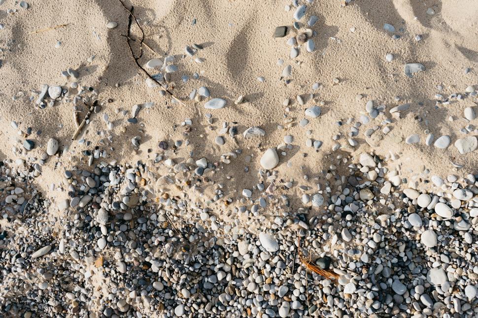 Free Image of Close Up of Sand and Rocks on a Beach 