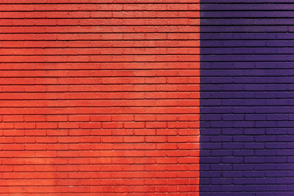 Free Image of Orange and Purple Brick Wall With Bench 