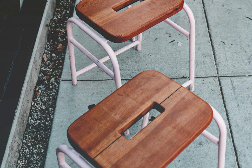 Free Image of Wooden Chairs on Sidewalk 