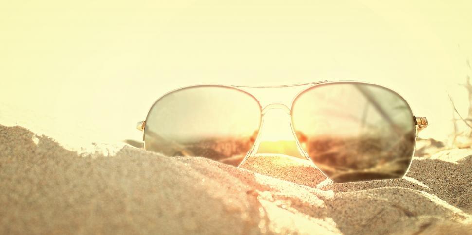 Free Image of Sunglasses on the Sand at Sunset - Beach Holidays 