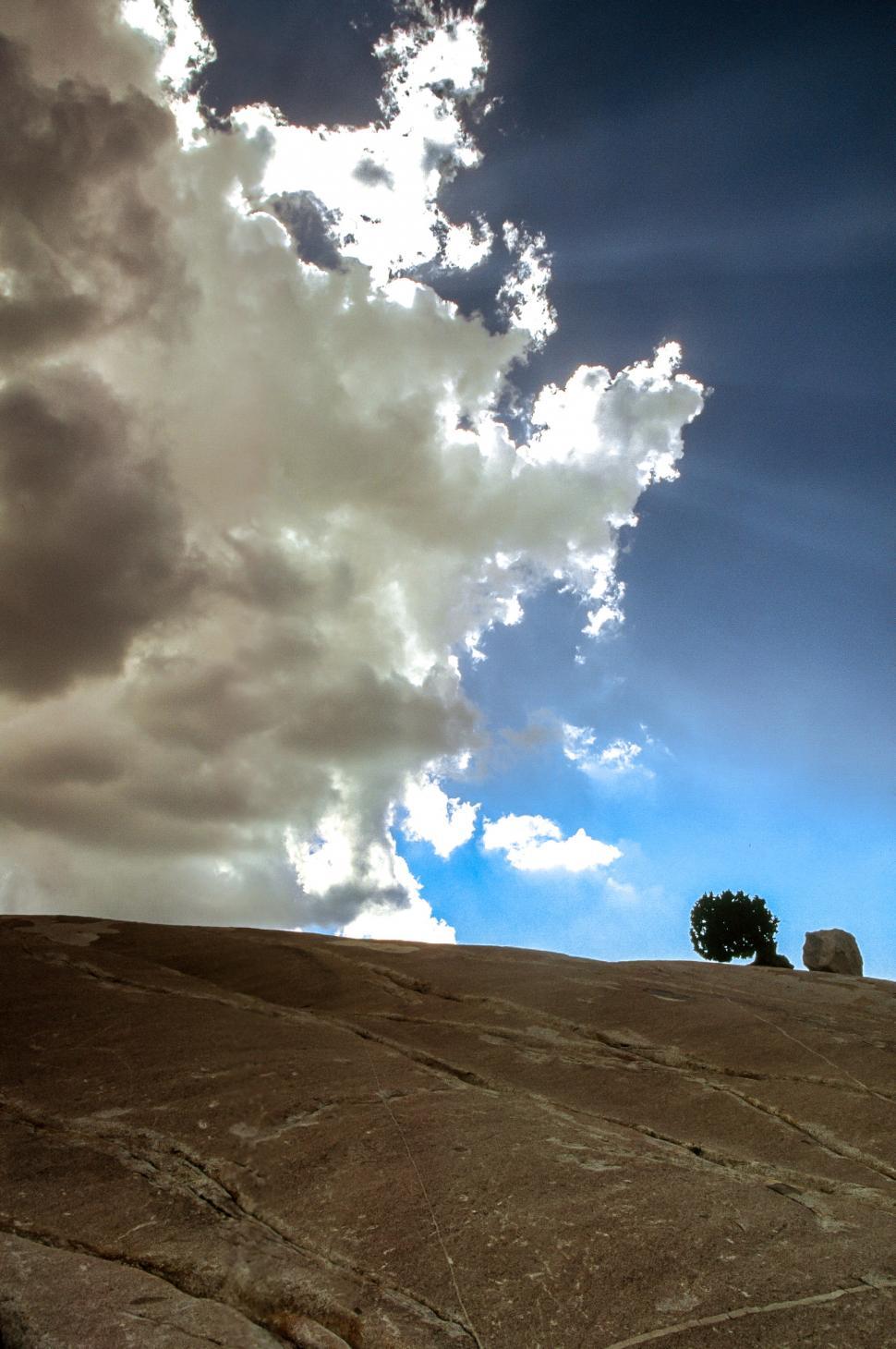 Free Image of Cloudscape over rocks 