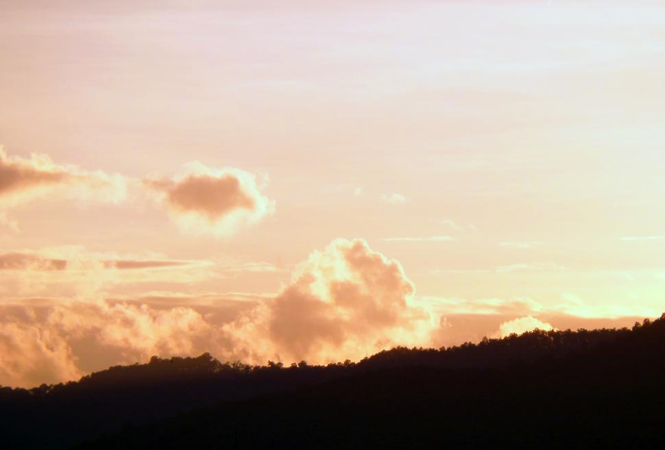 Free Image of Evening sky over forested hills  