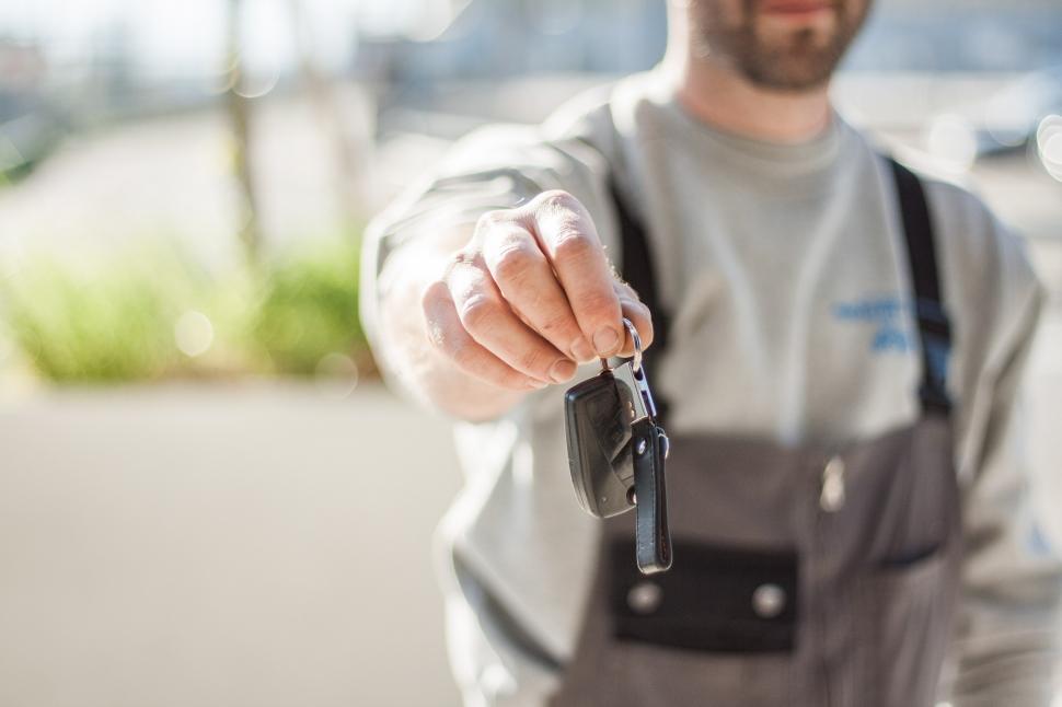 Free Image of Man in Apron Holding Car Key 