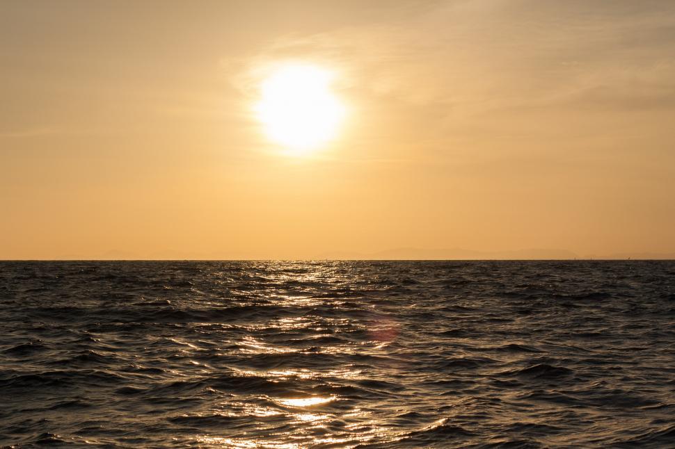 Free Image of Sun Setting Over Ocean Waters 