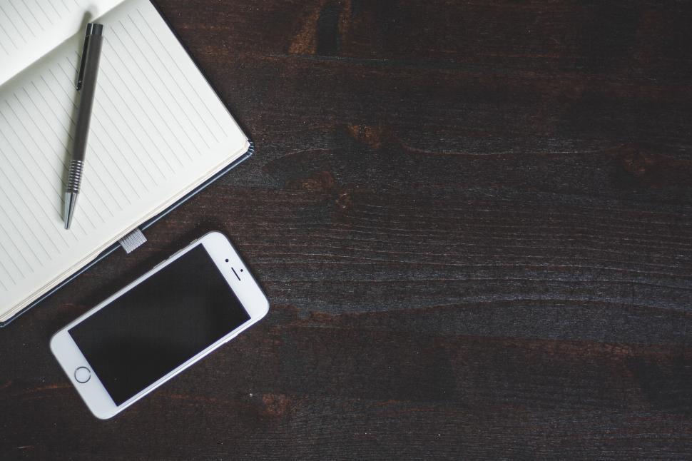 Free Image of Notepad, Pen, and Cell Phone on Desk 