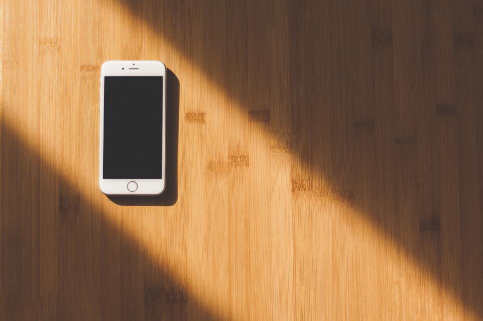 Free Image of Cell Phone on Wooden Table 
