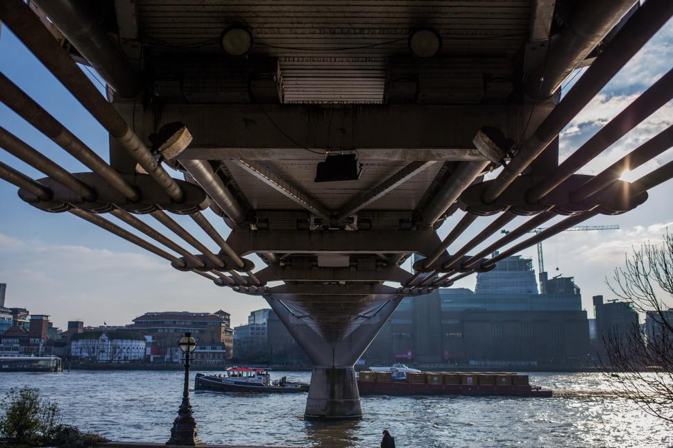Free Image of The Underside of a Bridge Over a Body of Water 