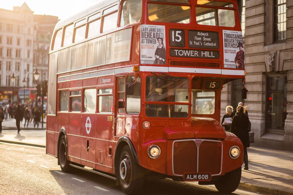 Free Image of Red Double Decker Bus Driving Down City Street 
