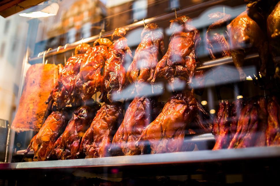 Free Image of Display of Fresh Chicken Hanging in Store Window 