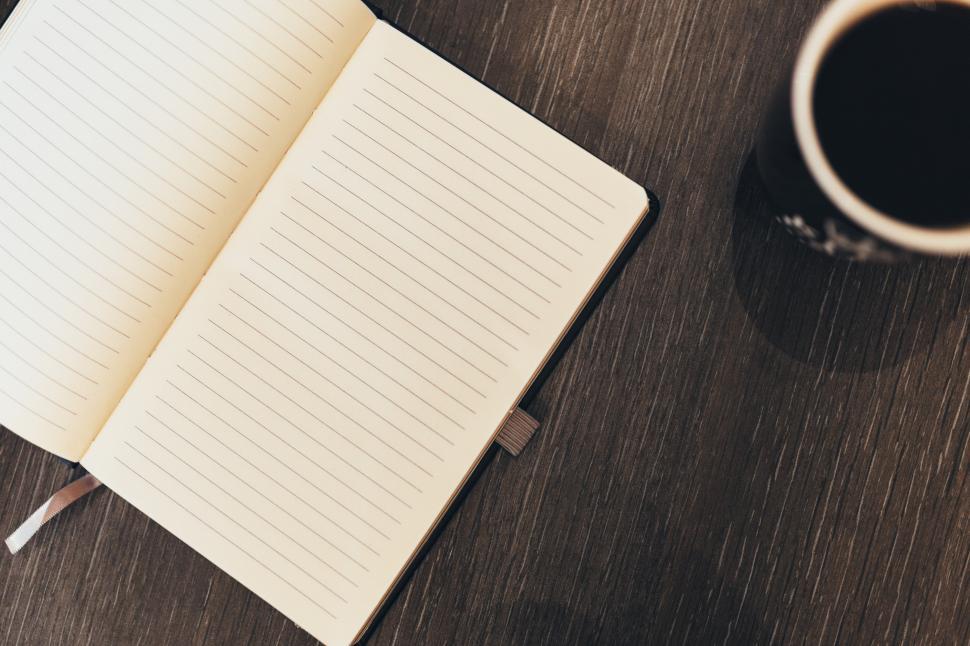 Free Image of Open Notebook and Coffee Cup on Wooden Table 