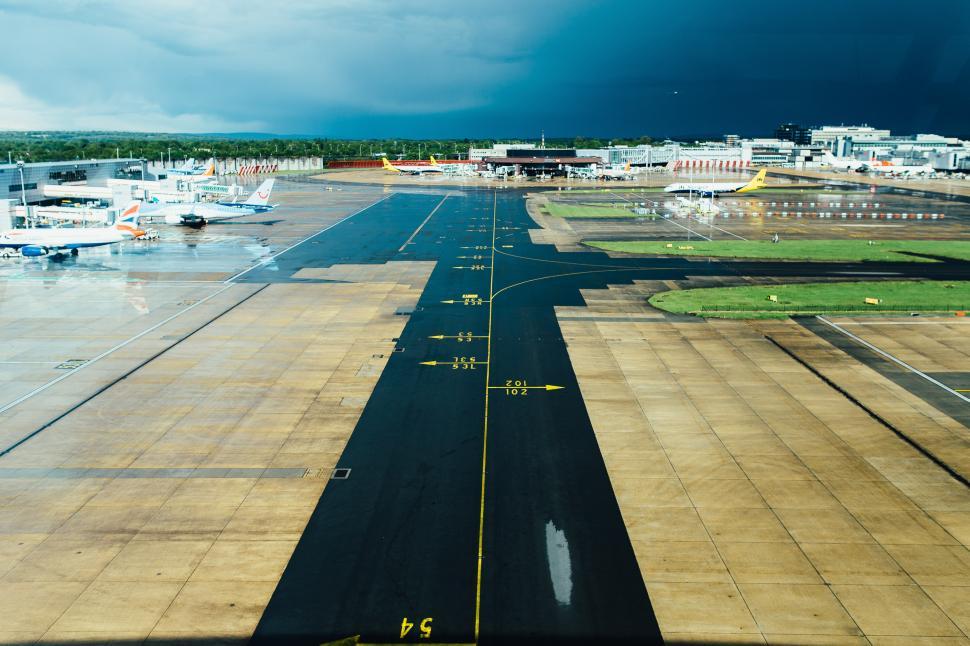 Free Image of Multiple Planes Parked on Airport Runway 