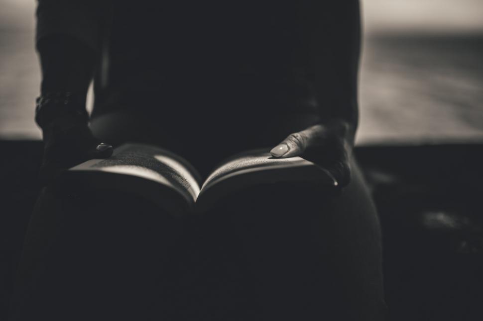 Free Image of Person Sitting Down Reading a Book 