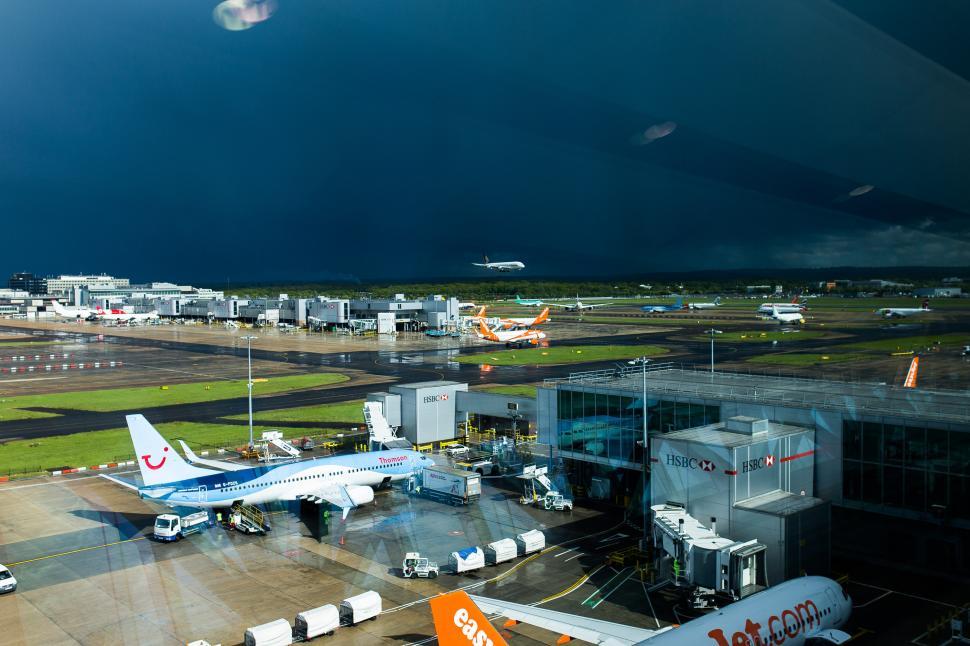 Free Image of Airplane Parked at Airport With Dark Sky 
