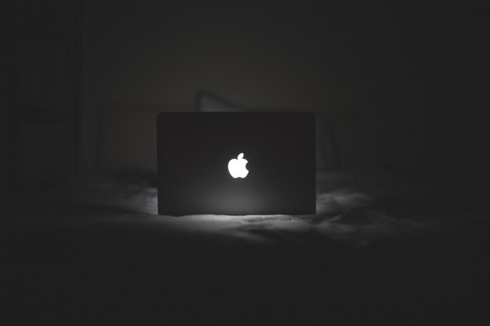 Free Image of Apple Laptop on Bed in Dark 