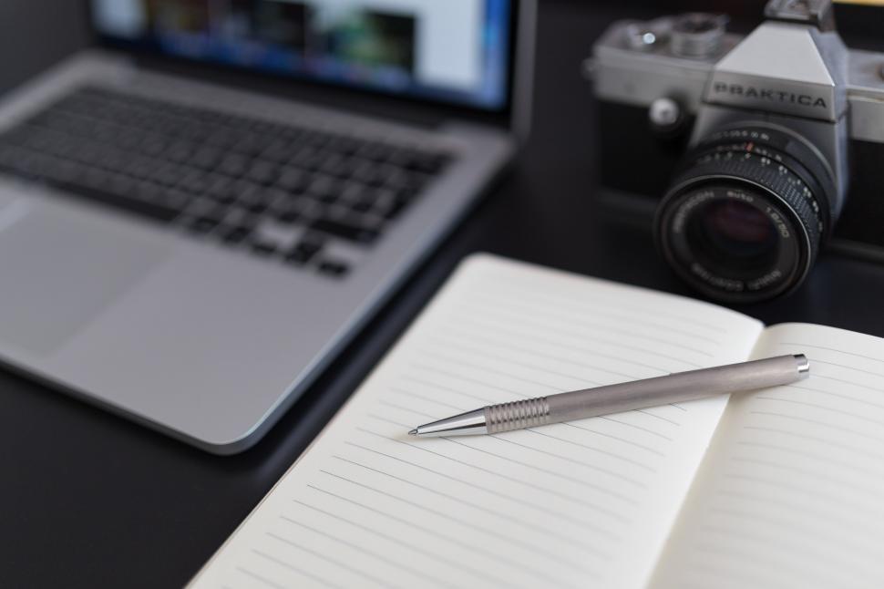 Free Image of Camera, Notebook, and Pen on Desk 