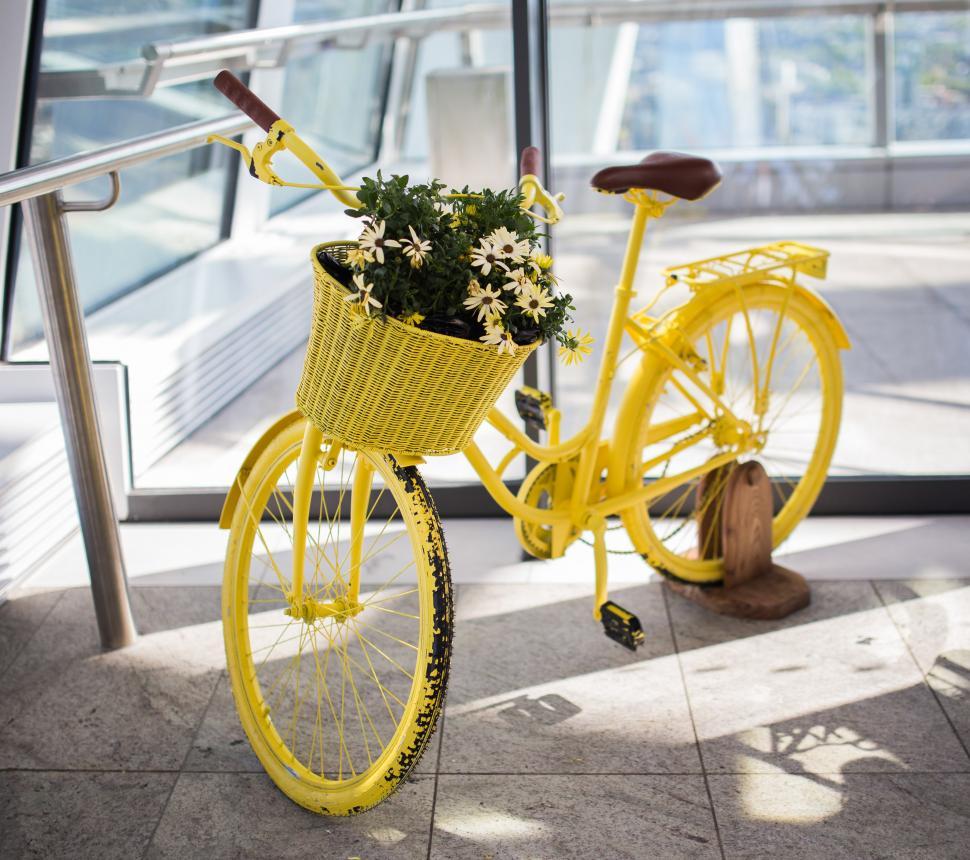 Free Image of Yellow Bicycle With Basket of Flowers 