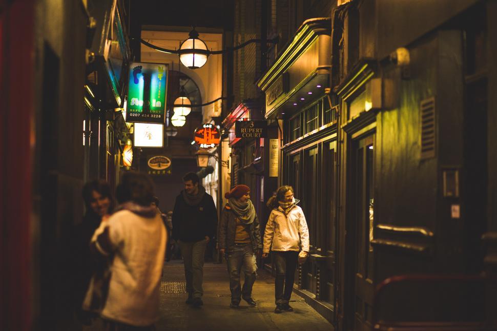 Free Image of Group of People Walking Down Dark Alleyway 