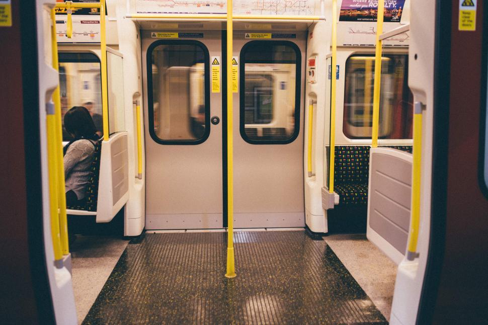 Free Image of Person Sitting on Train With Head Down 