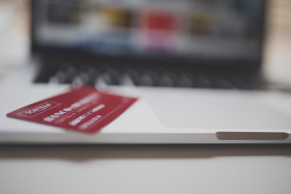 Free Image of Red Credit Card on Top of Laptop Computer 