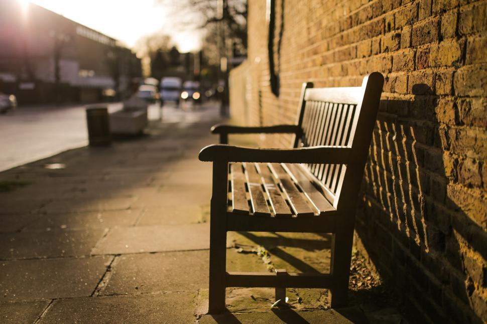 Free Image of Wooden Bench Next to Brick Wall 