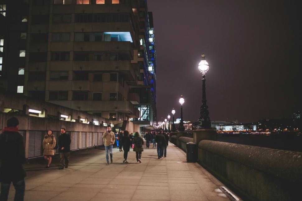 Free Image of Group of People Walking Across Bridge at Night 