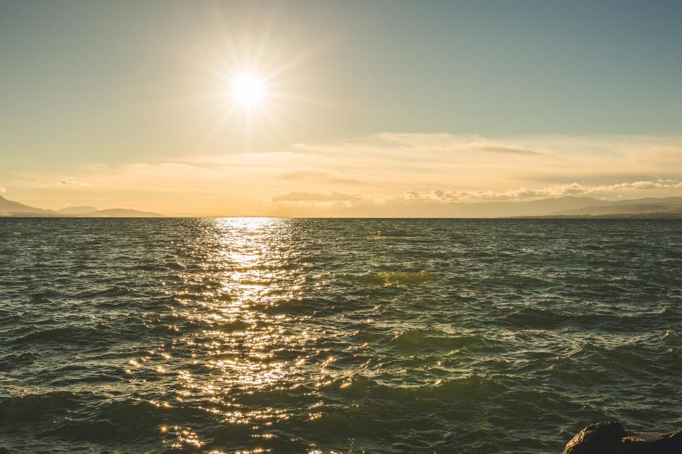 Free Image of Sun Setting Over Ocean With Waves 