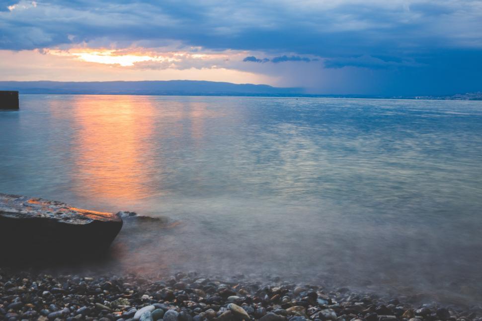 Free Image of Boat Resting on Rocky Beach 