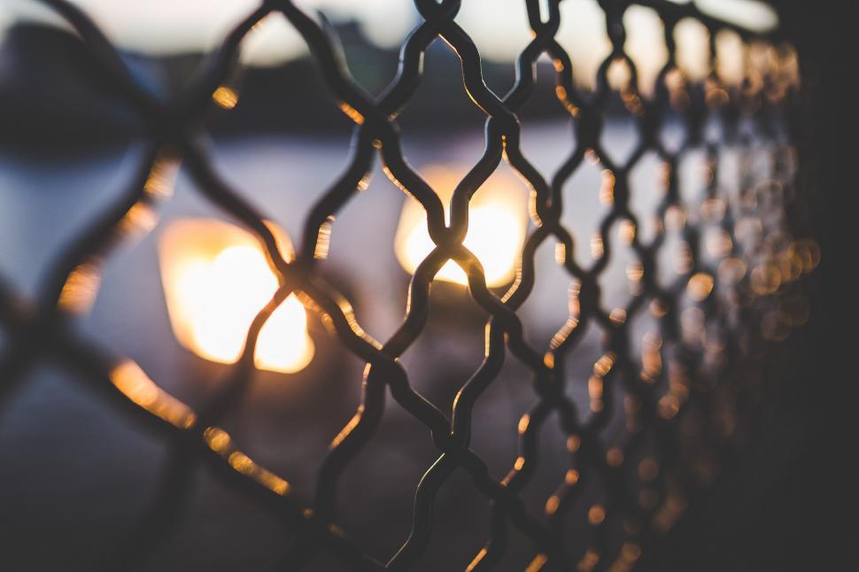 Free Image of Chain Link Fence Close Up With Background Light 