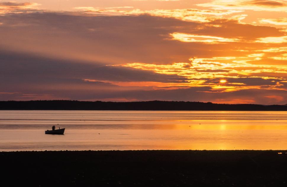 Free Image of Sunset with boat over water 