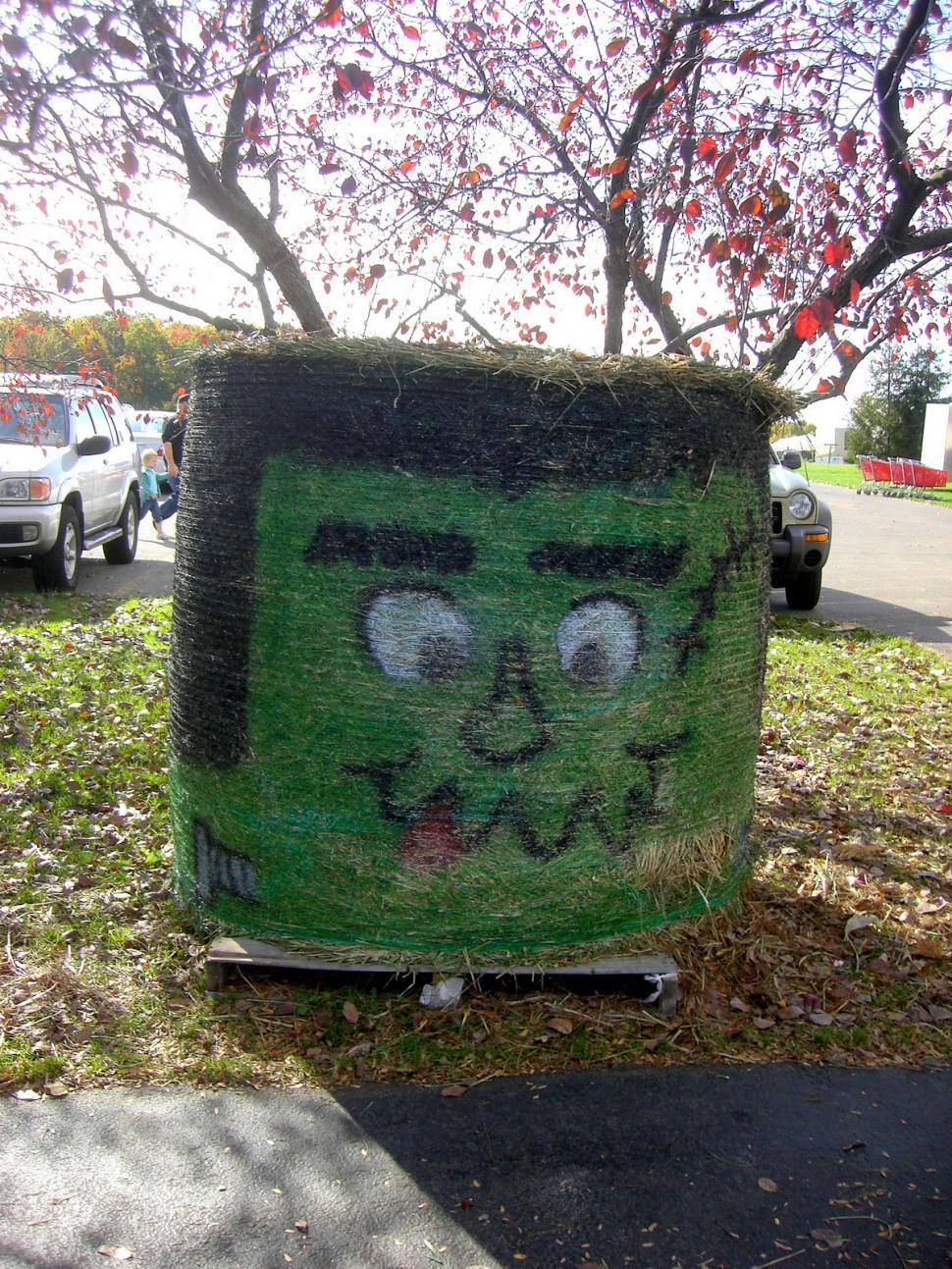 Free Image of Personified Trash Can With Face Painted On It 