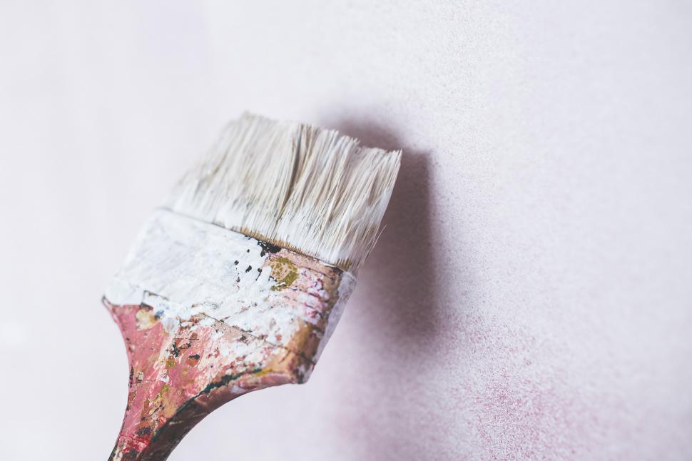 Free Image of Paintbrush Applying White Paint on White Wall 