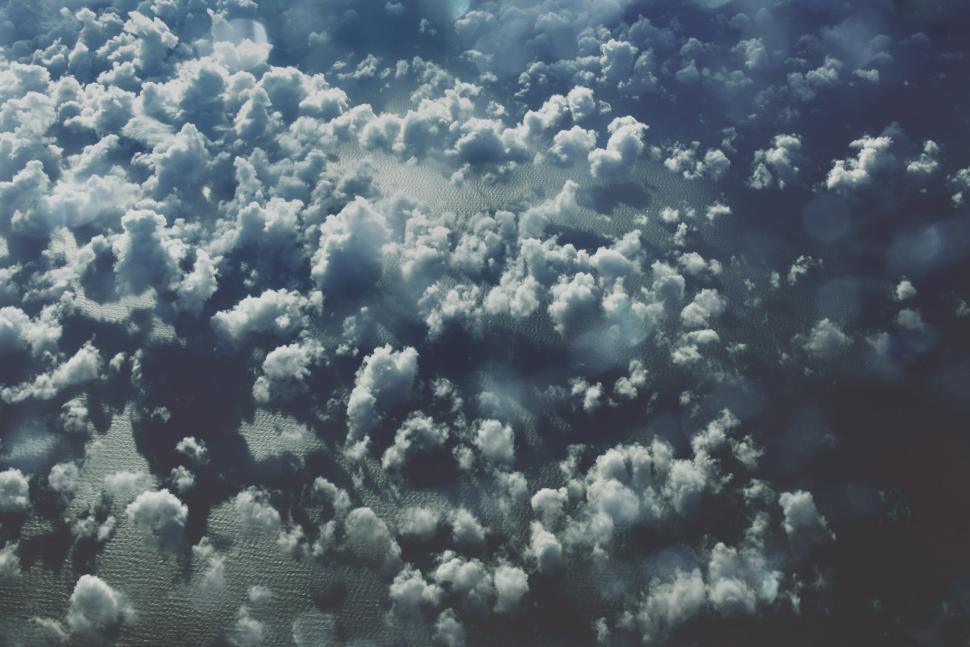 Free Image of Aerial View of Clouds Over a Body of Water 