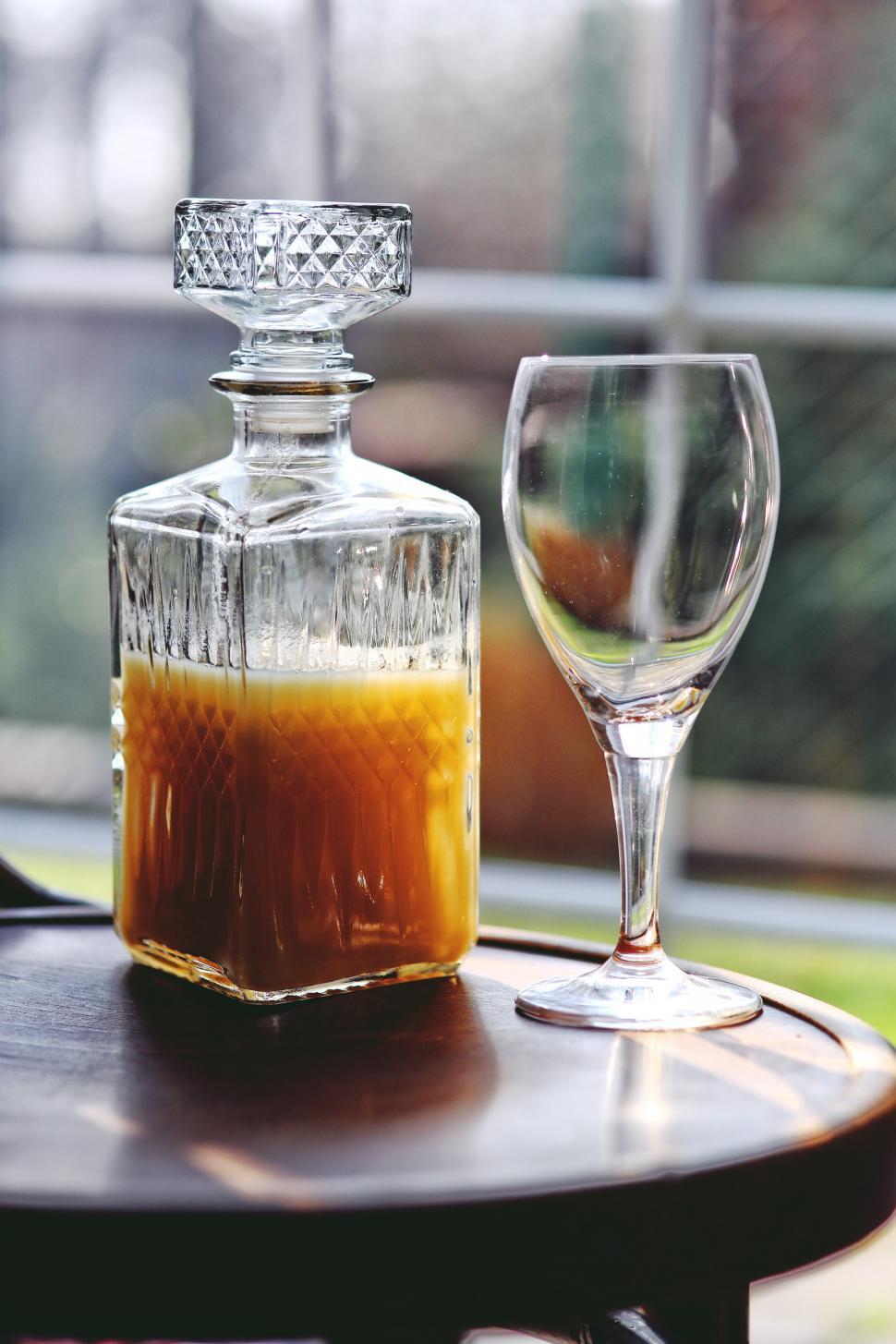 Free Image of Bottle of Alcohol and Glass on Table 