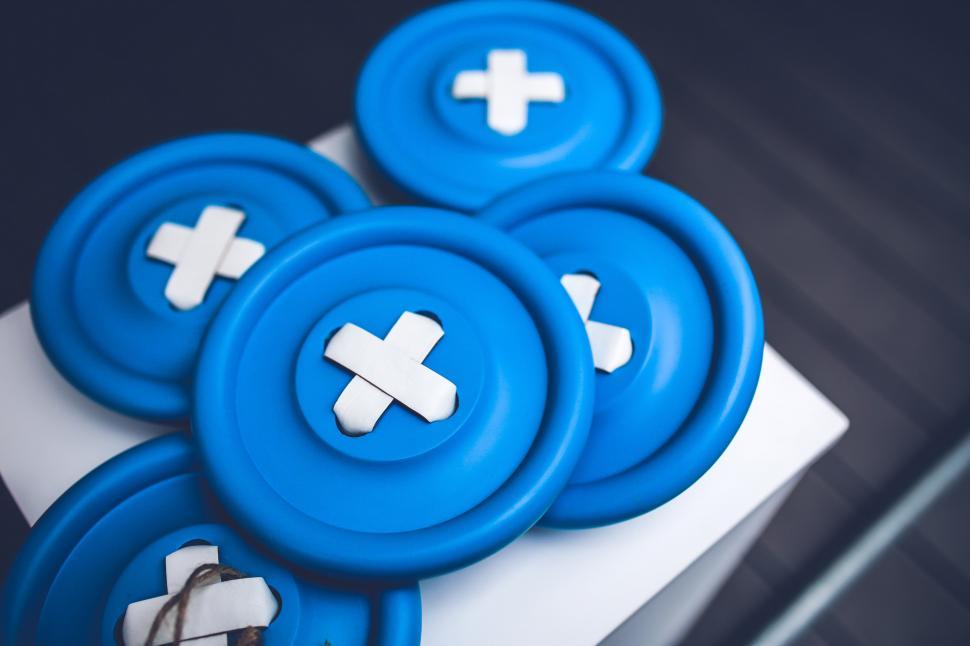 Free Image of Three Blue Buttons With White Crosses 