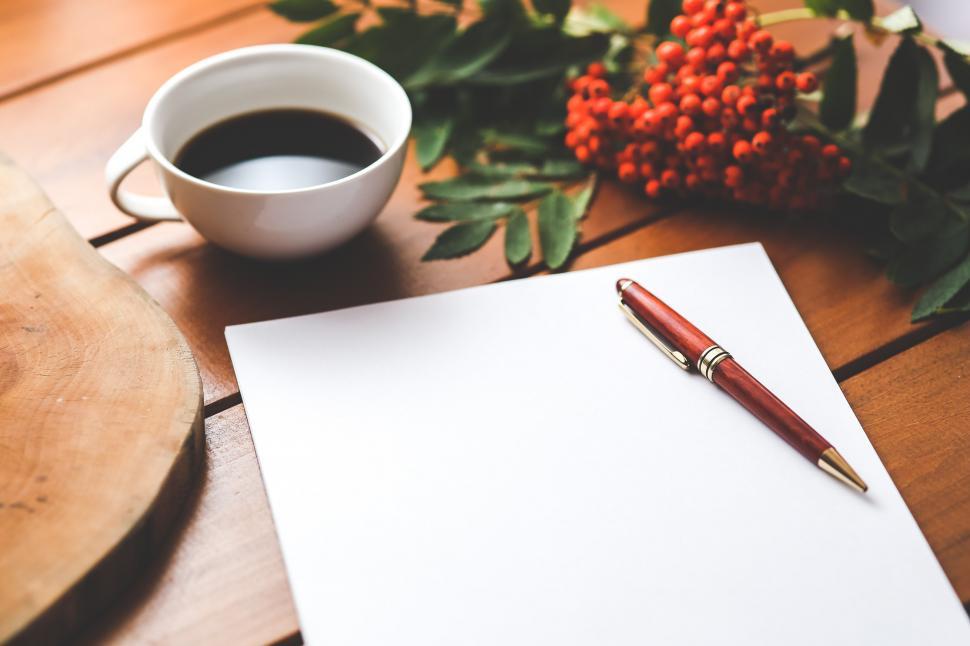 Free Image of A Cup of Coffee and a Pen on a Table 