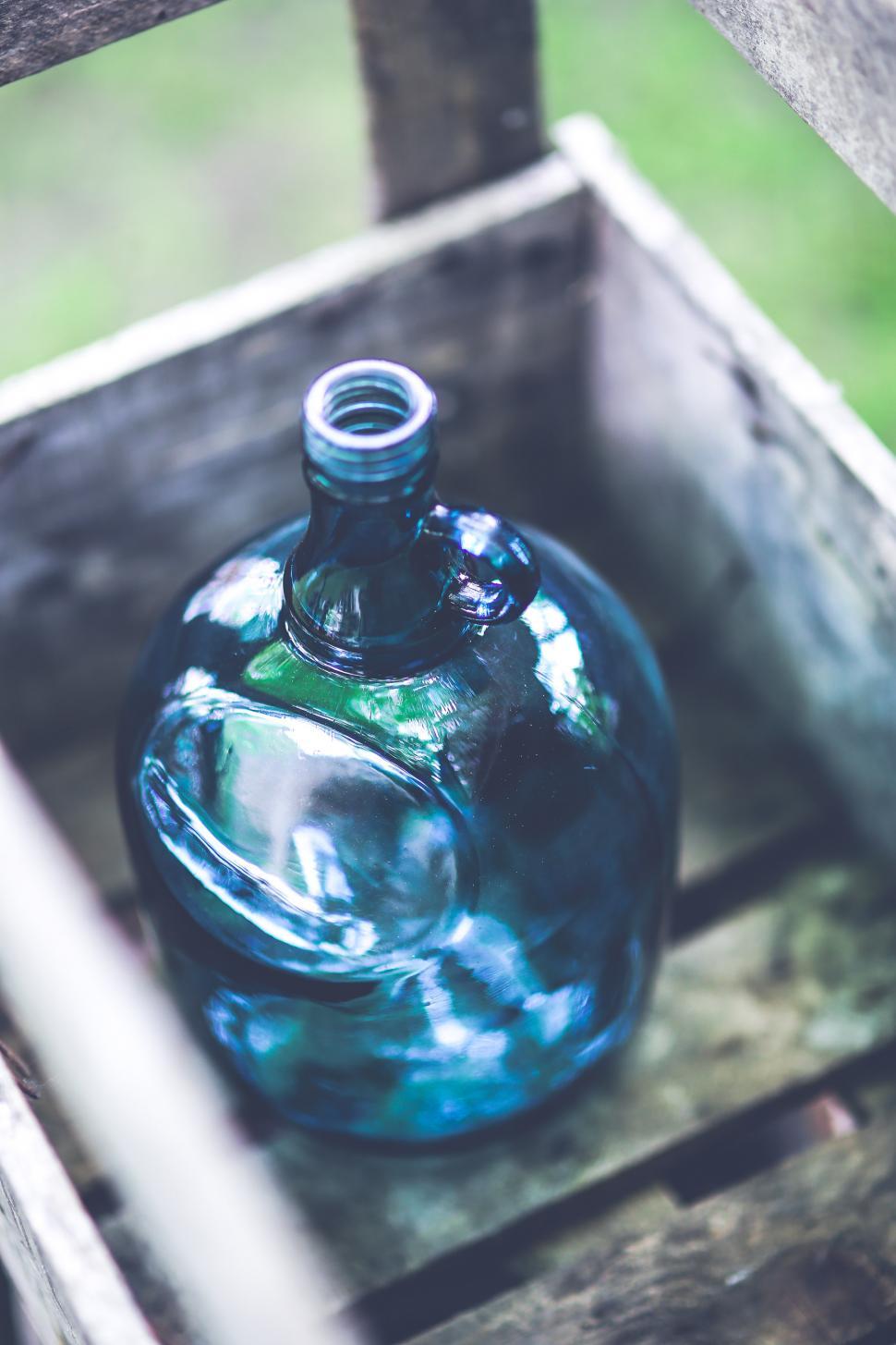 Free Image of Blue Glass Bottle in Wooden Box 