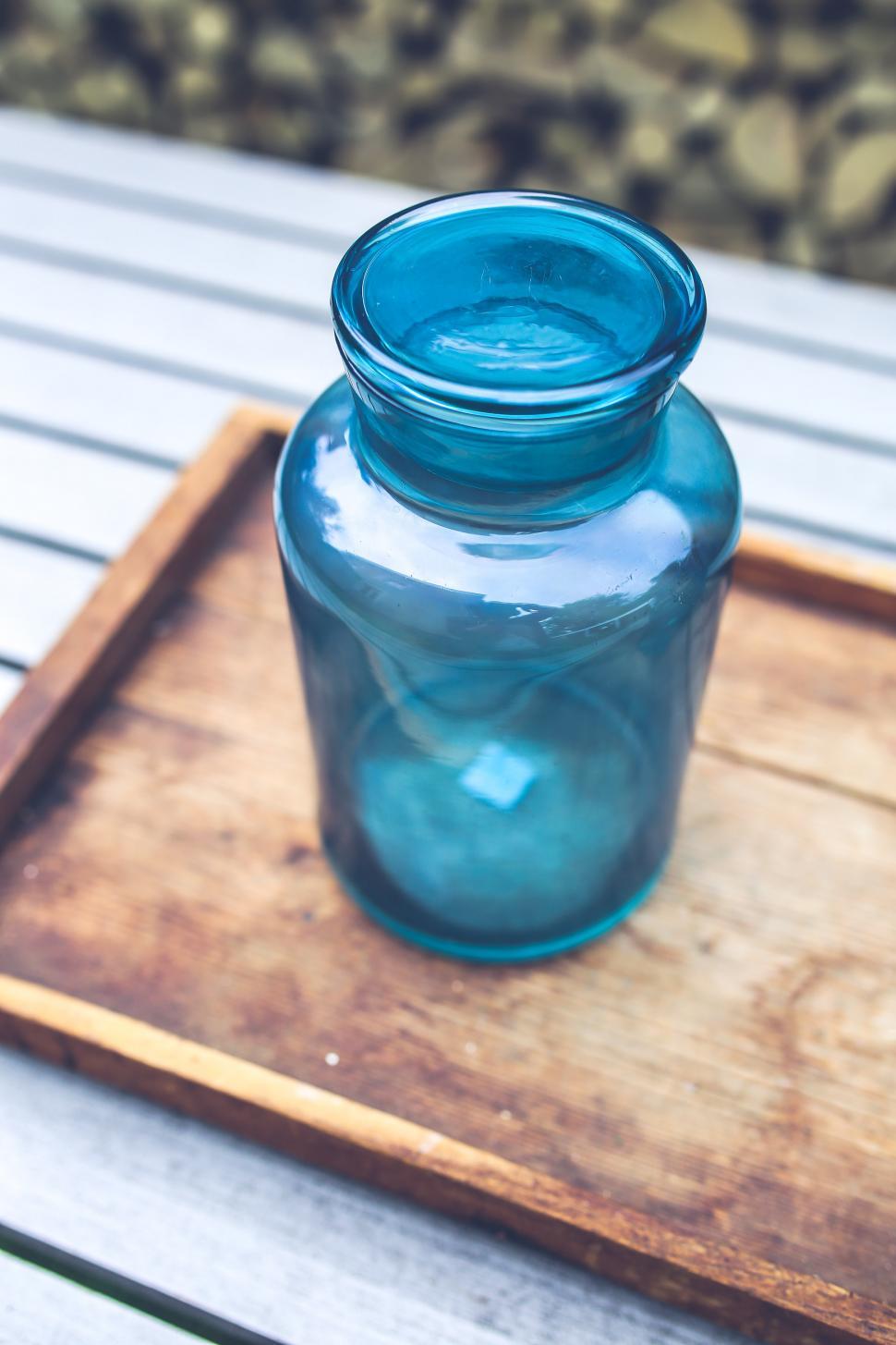 Free Image of Blue Wood big design exhibition glass homeware jar tray wooden container bottle water bottle vessel saltshaker shaker liquid water 