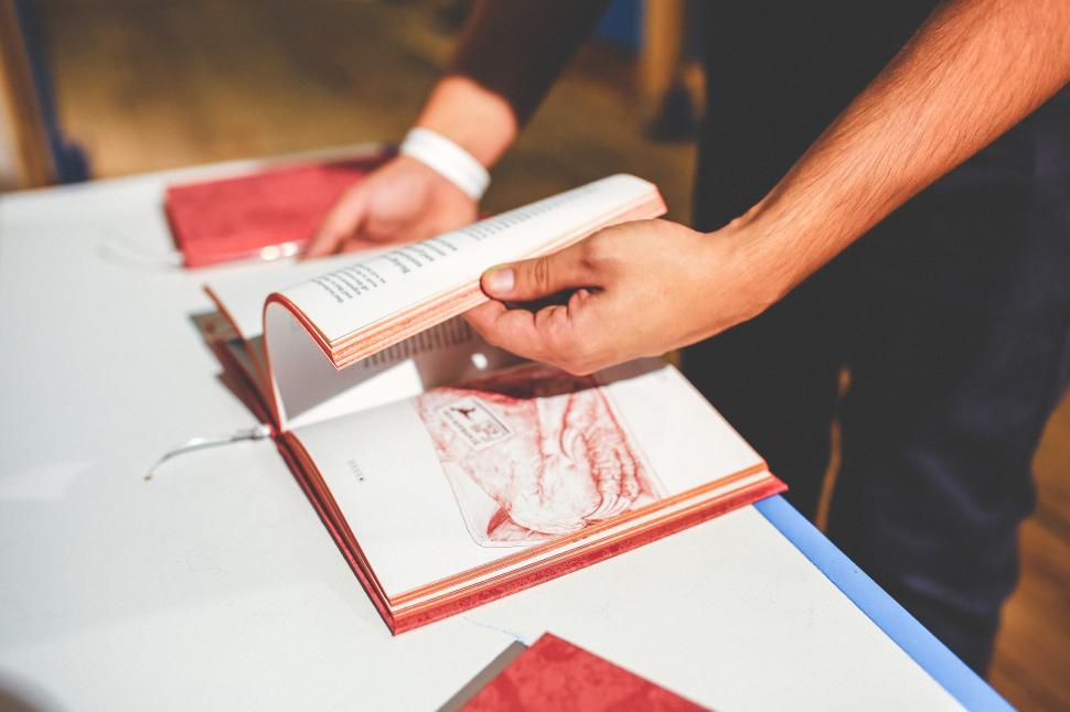 Free Image of Person Cutting Paper With Knife on Table 